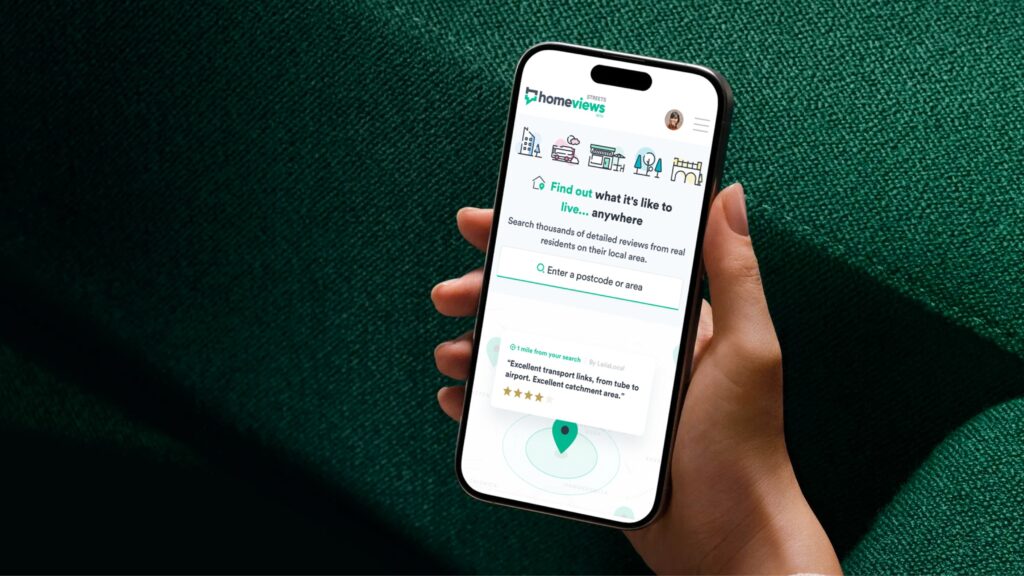 An hand holding a mobile device showing HomeViews Streets progressive web app