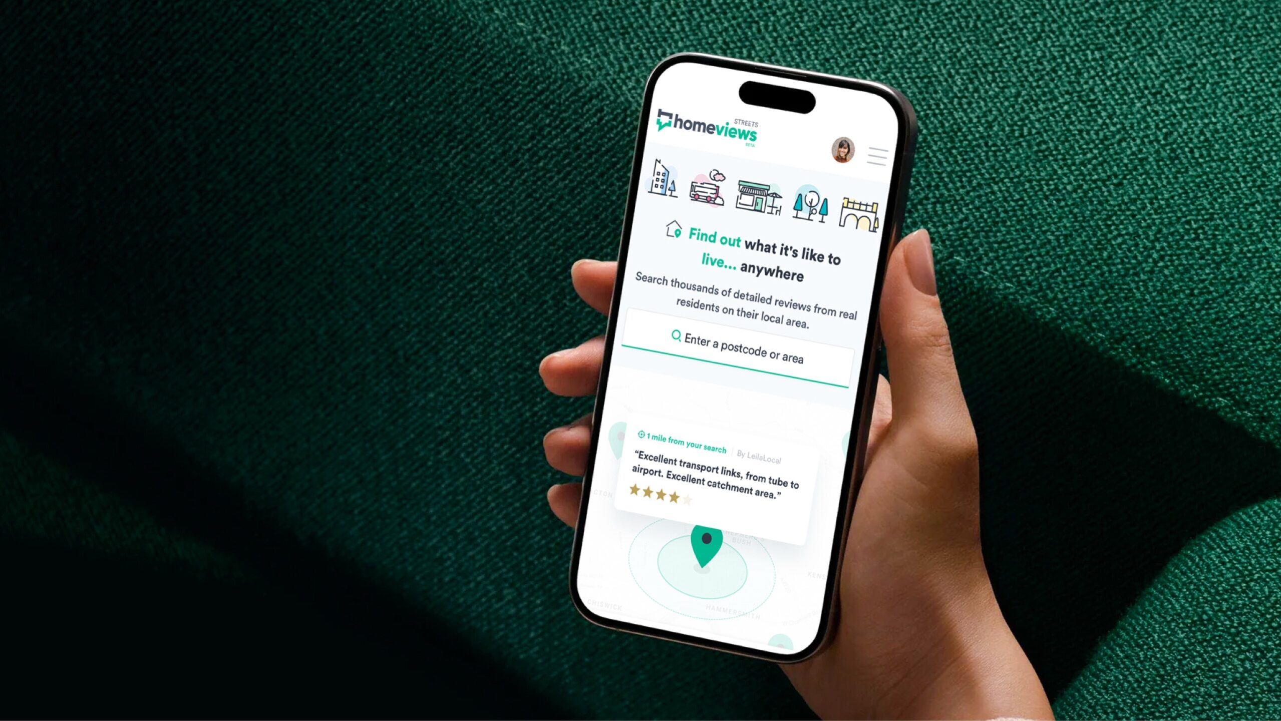 An hand holding a mobile device showing HomeViews Streets progressive web app